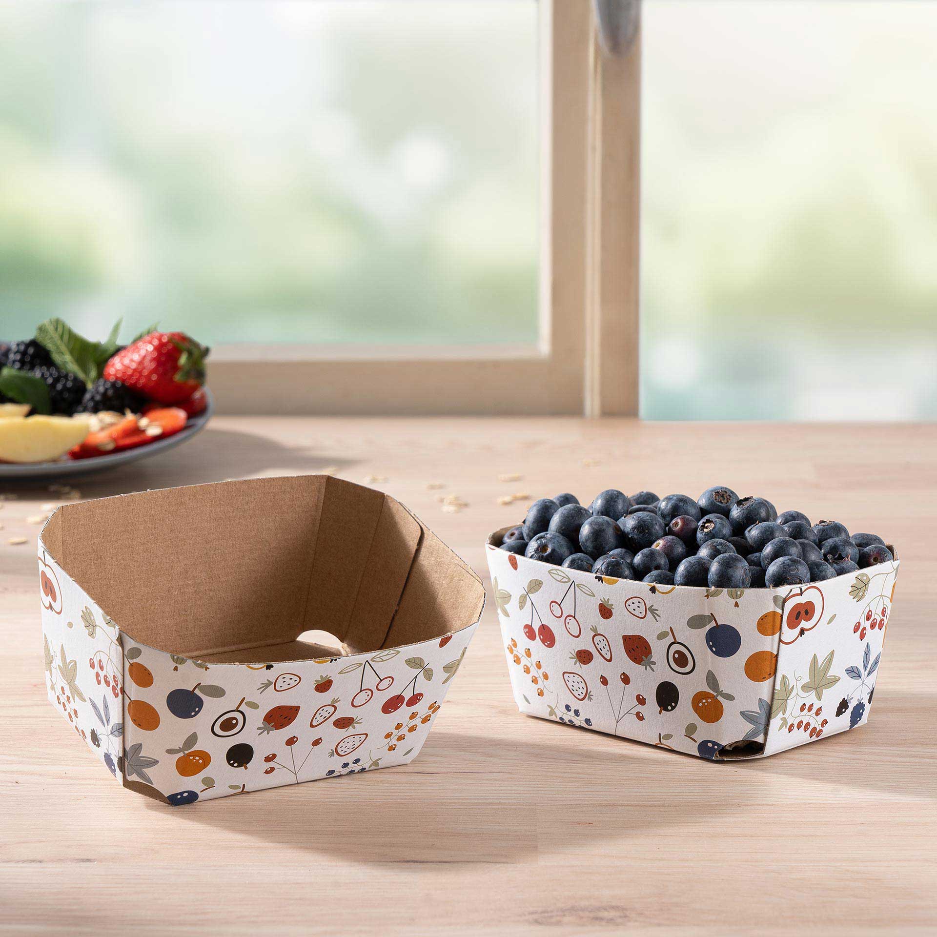 Zwei Beerenschalen aus Wellpappe 250g mit Blaubeeren auf einem Tisch