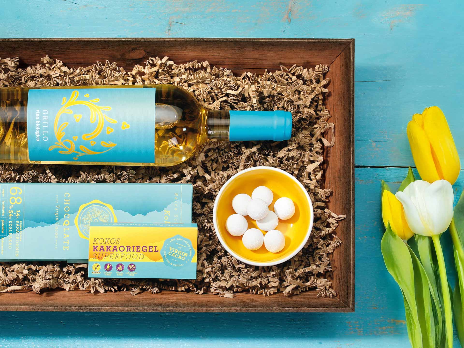 Präsentkorb Vintage mit Schokolade und Wein und seitlich Tulpen